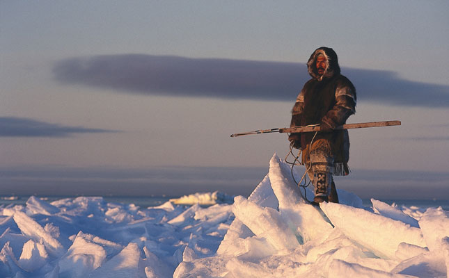Un cazador inuit sobre el hielo con su arpón